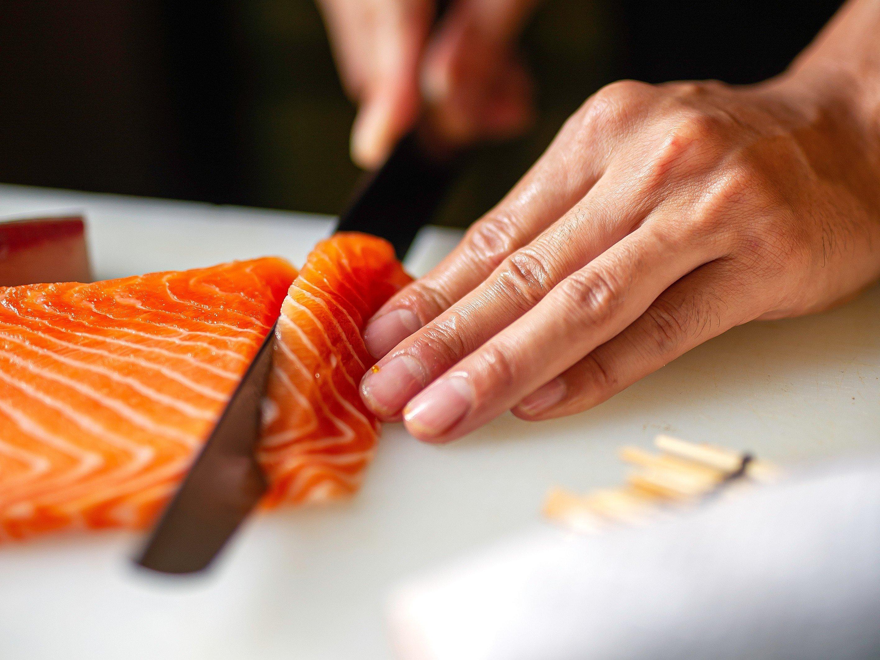 Cutting salmon closeup_wide